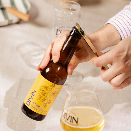 Divin Blonde alcohol-free beer 0.2% opening bottle with glass.