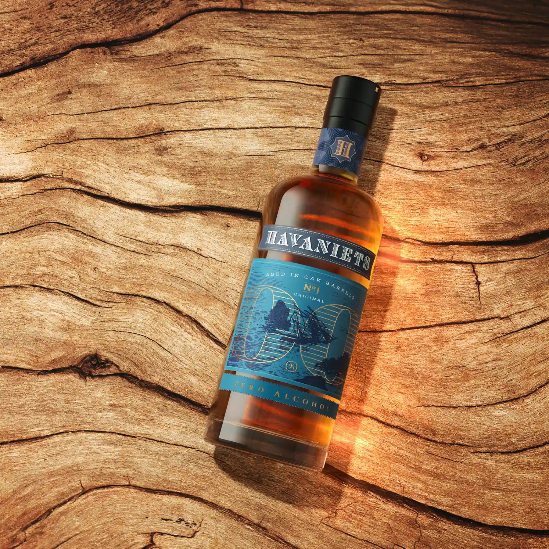 Havaniets Original alcohol-free rum-style spirit bottle on natural wood background.