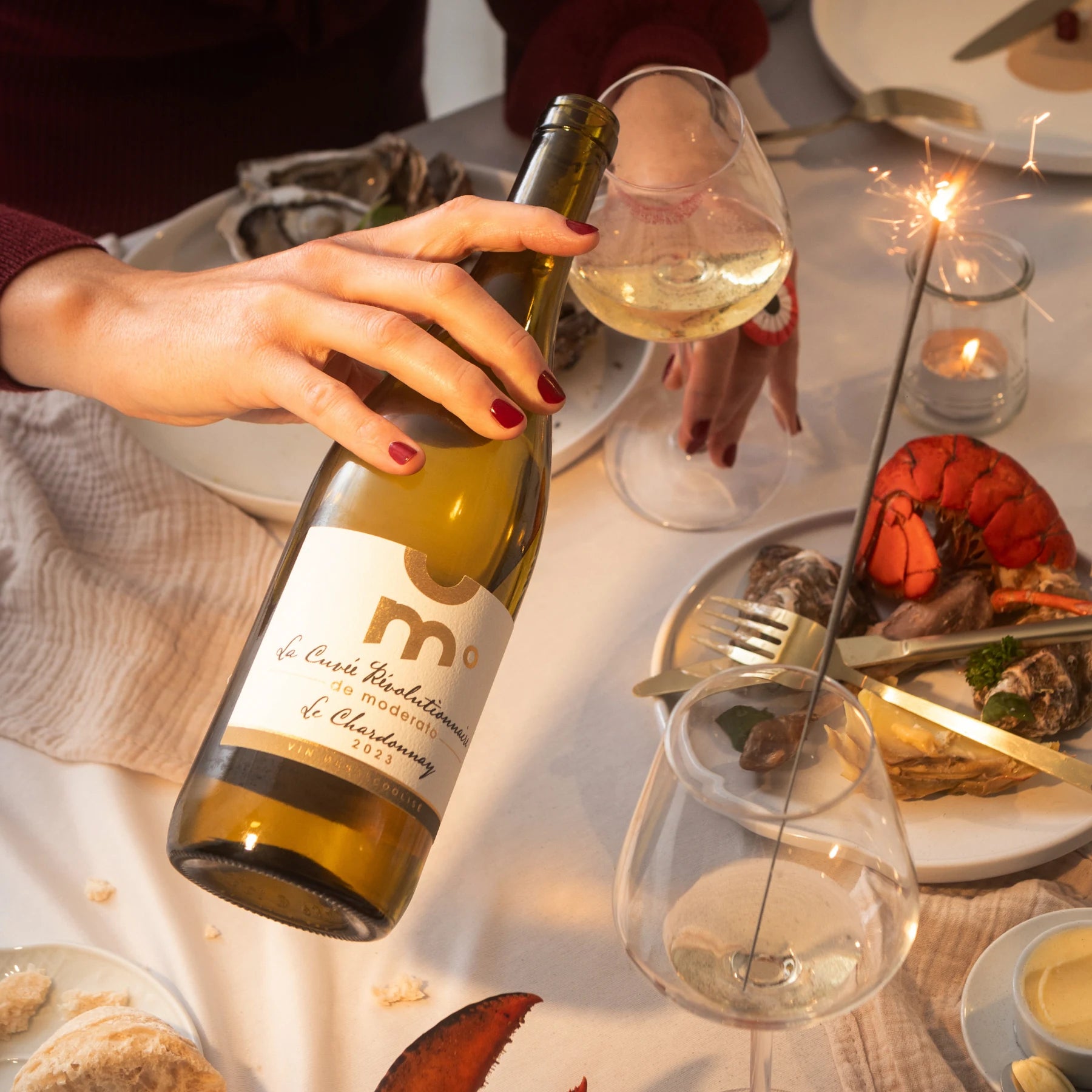 Moderato Chardonnay alcohol-free white wine poured into a glass during a seafood dinner, elegant food pairing.