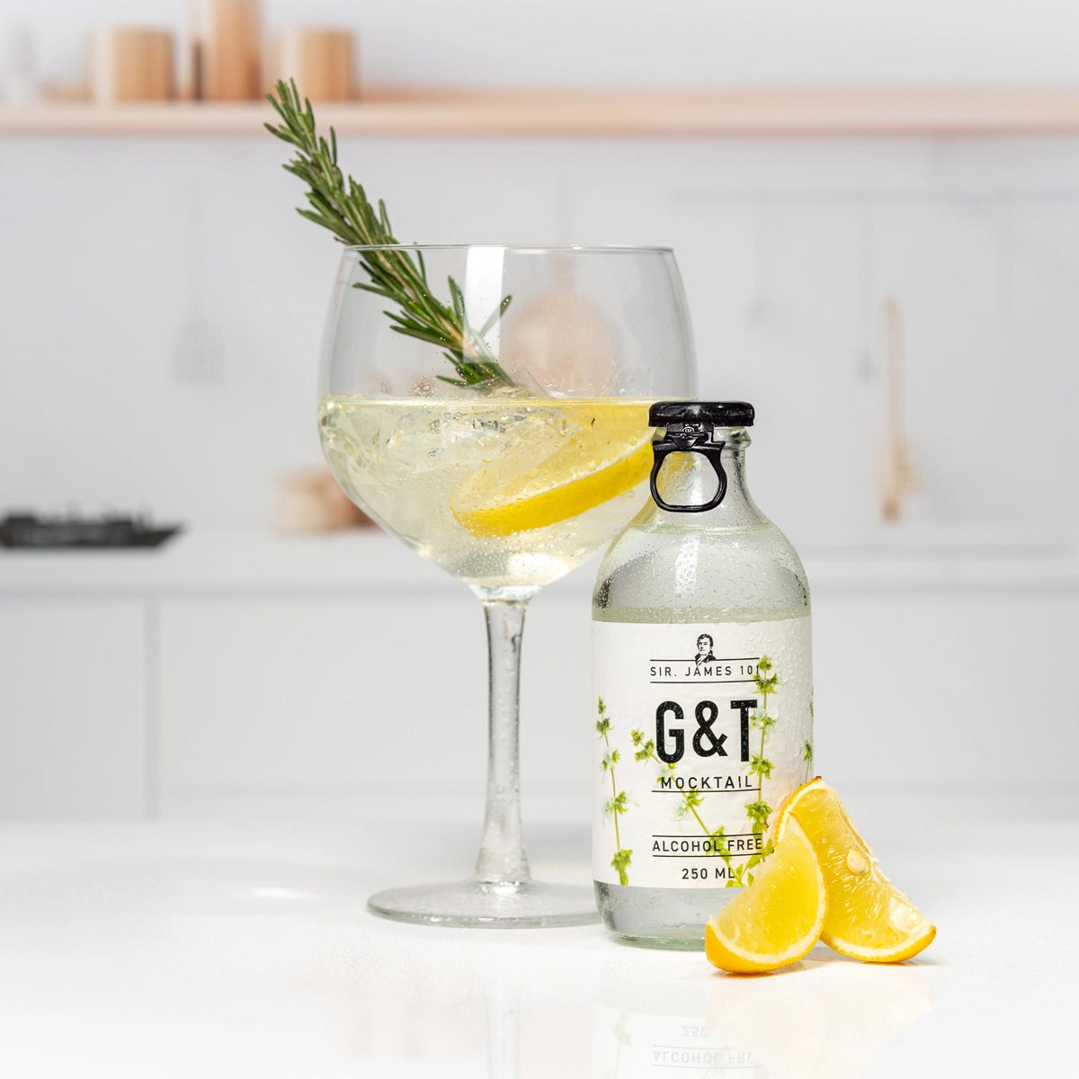 SIR. JAMES 101 Gin Tonic Alcohol Free 250 ml bottle with a glass of alcohol-free G&T, garnished with lemon slices and rosemary on a bright kitchen counter