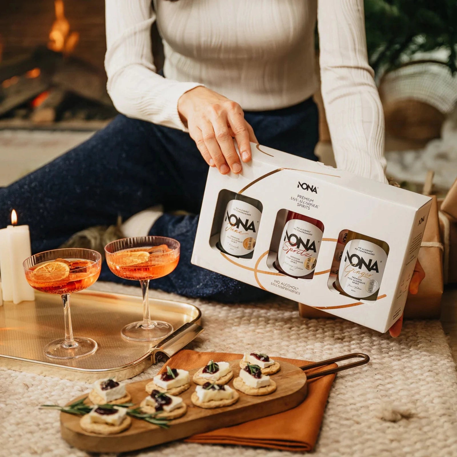 NONA alcohol-free spirits gift box presented with festive appetizers and elegant spritz cocktails