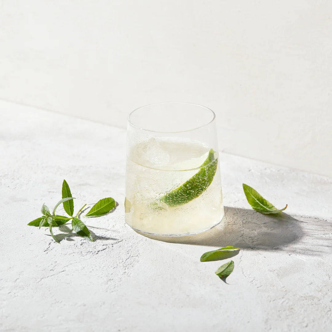 Refreshing cocktail made with NONA Ginger alcohol-free spirit, served with lime and fresh herbs