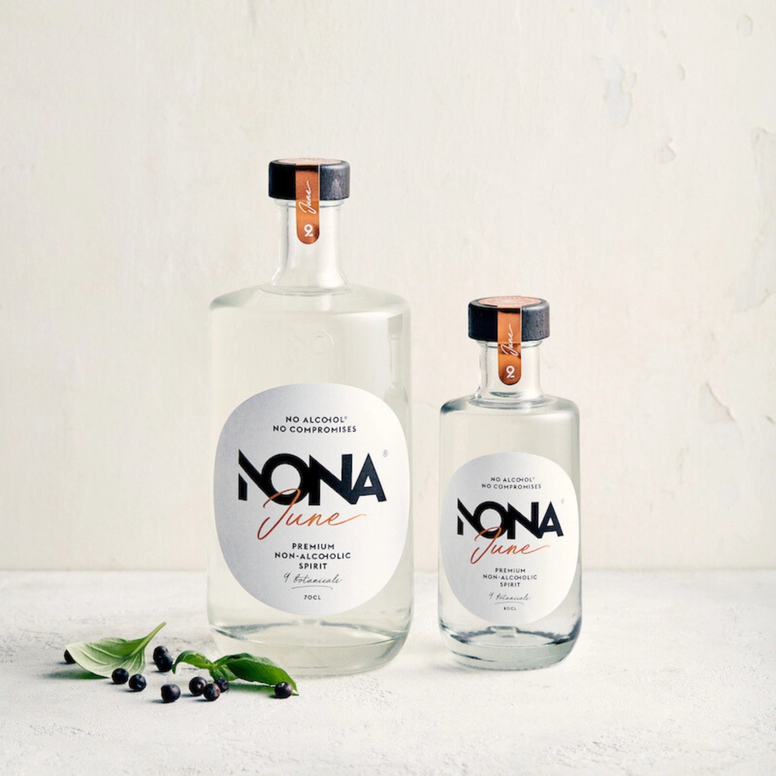 Two bottles 700 ml and 200 ml of NONA June on a light background