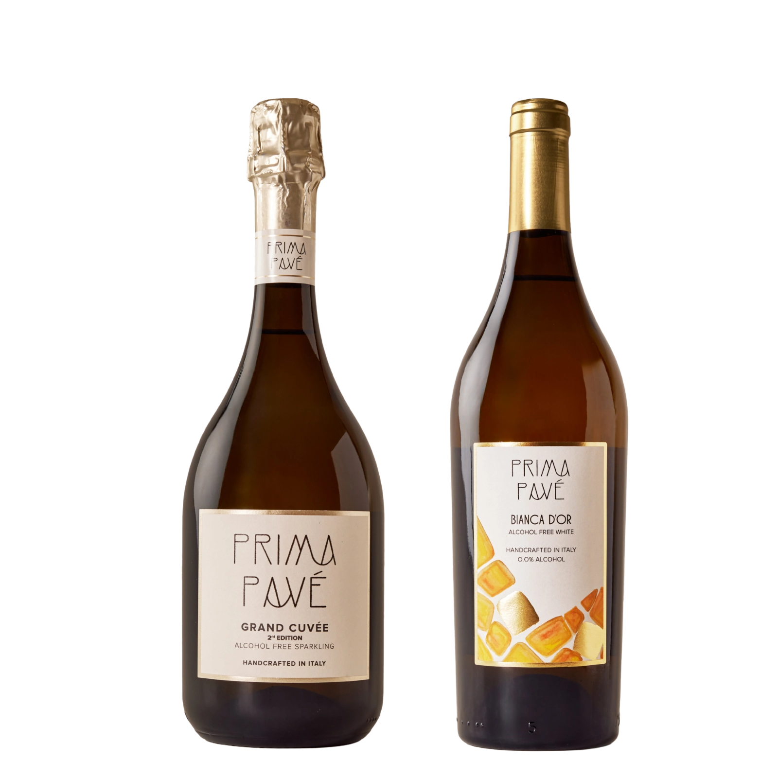 Two bottles of Prima Pavé non-alcoholic wine — Grand Cuvée sparkling and Bianca D'Or white — on a neutral background.