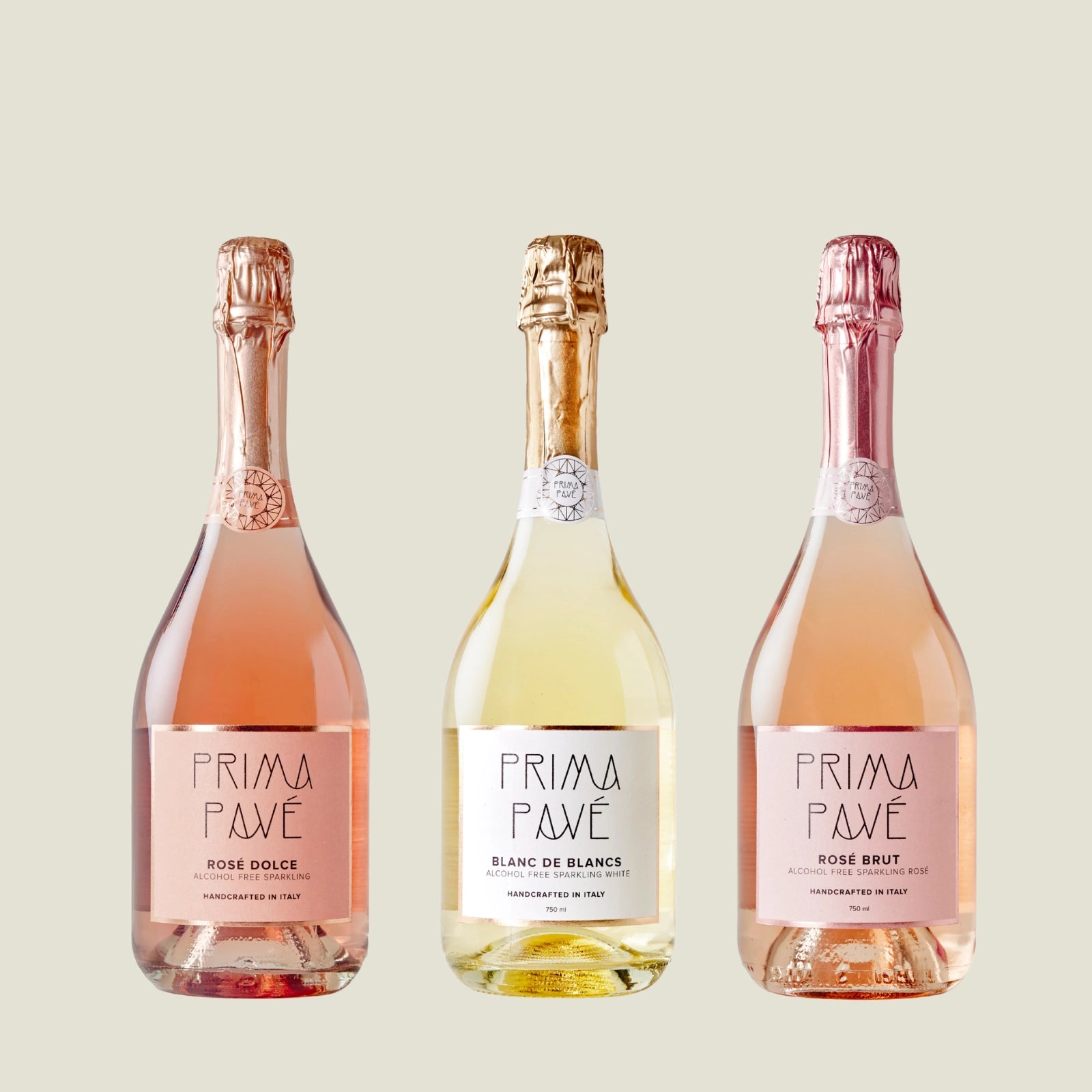 Close-up of three Prima Pavé alcohol-free sparkling wines — Rosé Dolce, Blanc de Blancs, and Rosé Brut — on a soft neutral background.