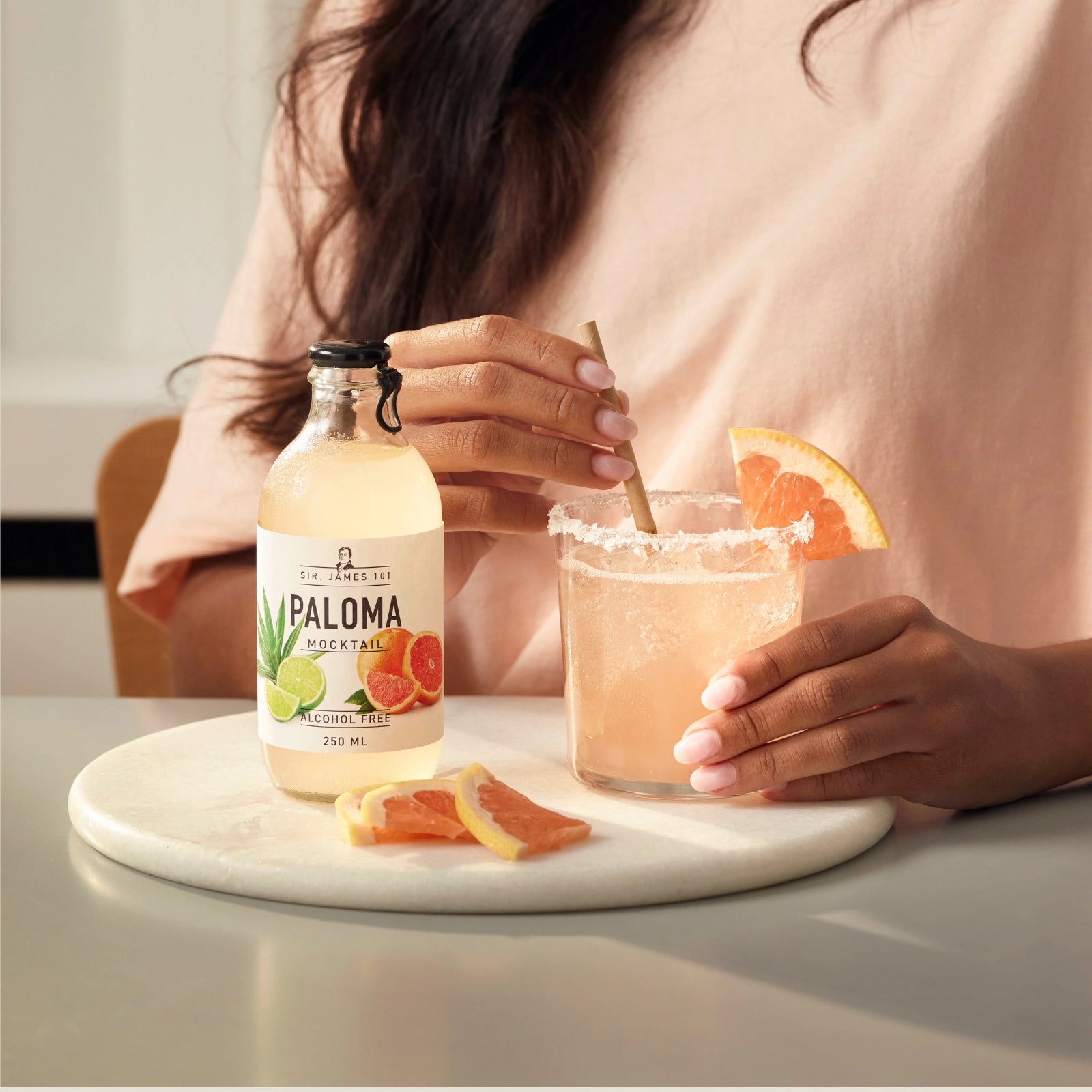 Sir James 101 Paloma alcohol-free mocktail served in a glass with grapefruit and salted rim