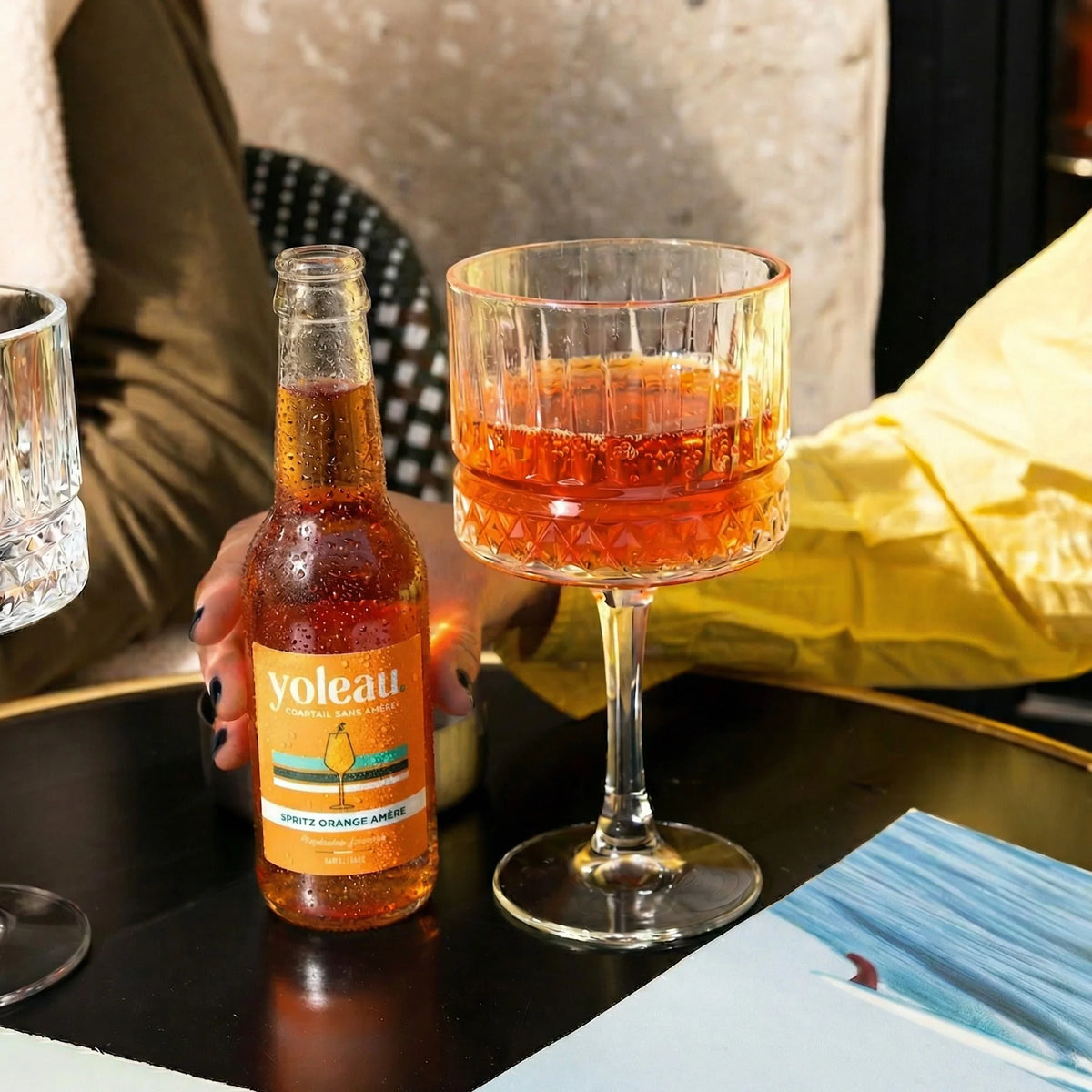 Yoleau Bitter Orange Spritz alcohol-free mocktail bottle with a served spritz in a stemmed glass.