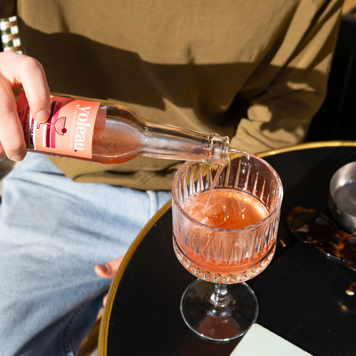 Yoleau Raspberry Timut Spritz alcohol-free mocktail being poured into a glass.